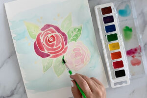 Hand painting flowers with watercolor paint