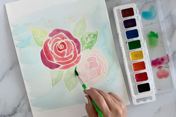 Hand painting flowers with watercolor paint