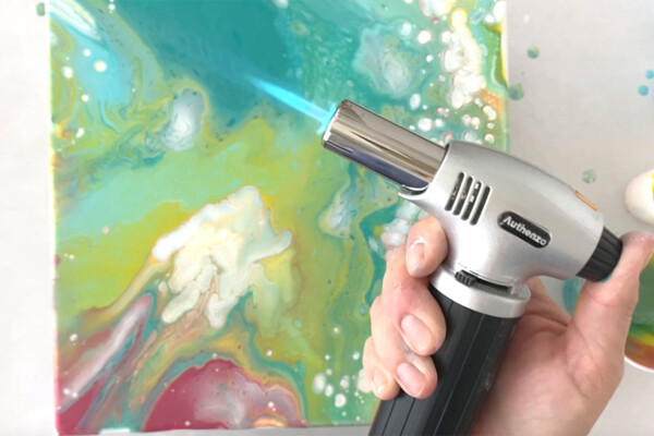 Kitchen blow torch used to pop bubbles in paint
