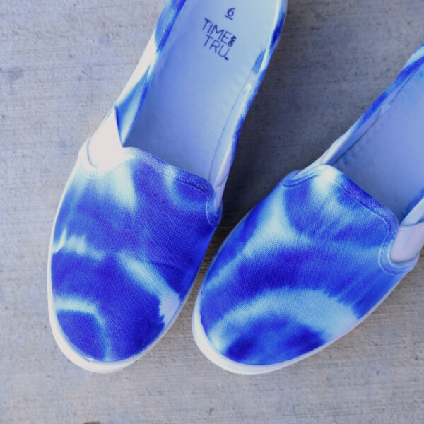 Pair of shoes that have been dyed with blue sharpie