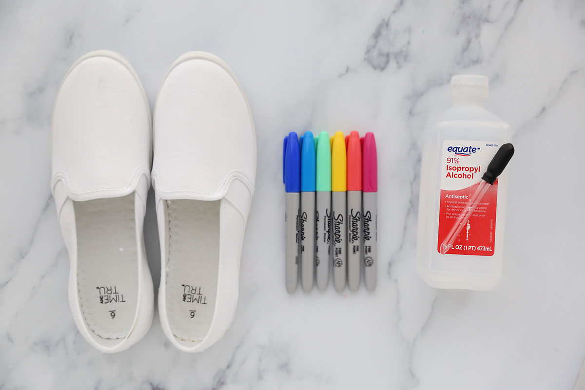 Revive tired white canvas shoes with black fabric marker doodles