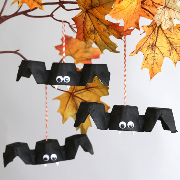 Egg carton bat craft hanging from a branch