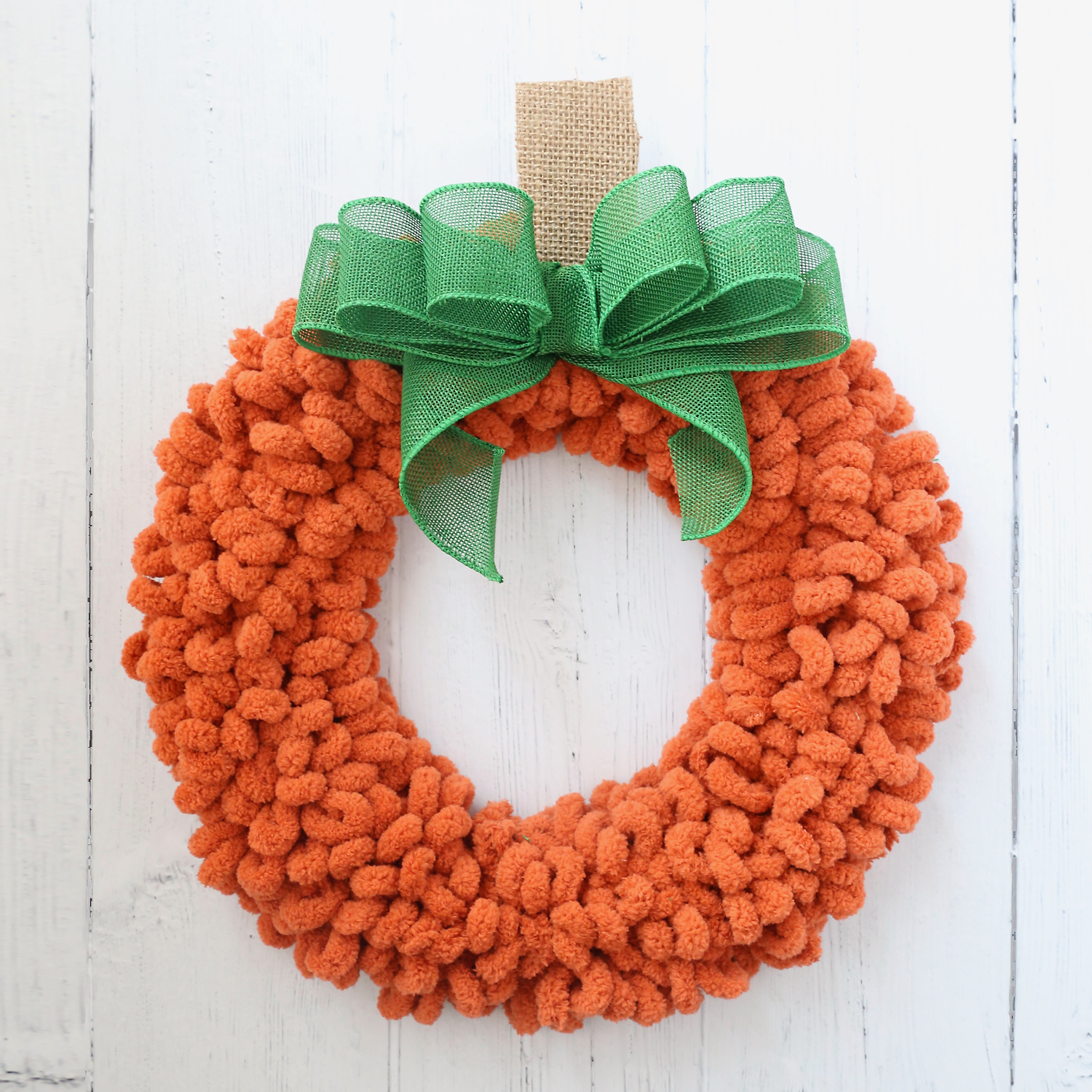 Easy DIY Pumpkin Wreath - It's Always Autumn Create your own festive pumpkin wreath with just a wire wreath form, some orange yarn, and a few faux leaves. This easy DIY project is perfect for adding a touch of autumn to your front door or wall decor.