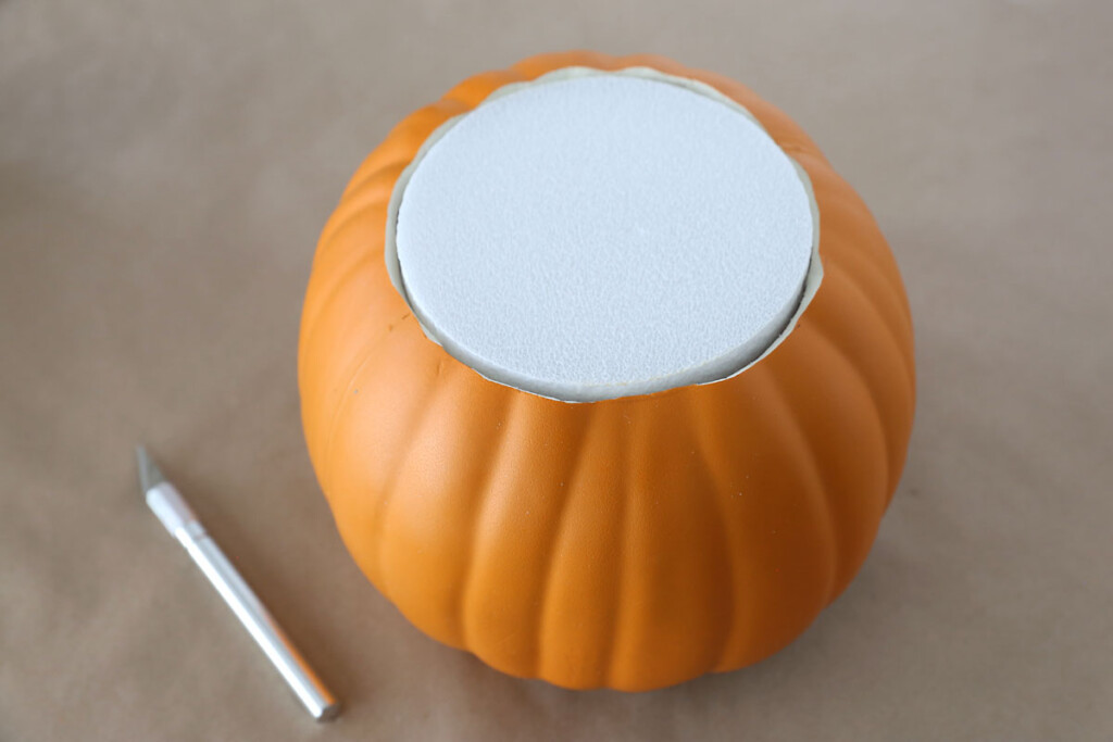 Faux pumpkin with top cut off; filled with round floral foam discs