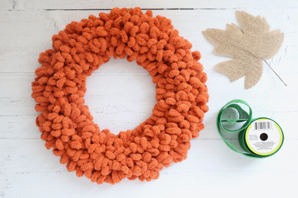 Orange loop yarn wreath; burlap leaf; green burlap ribbon