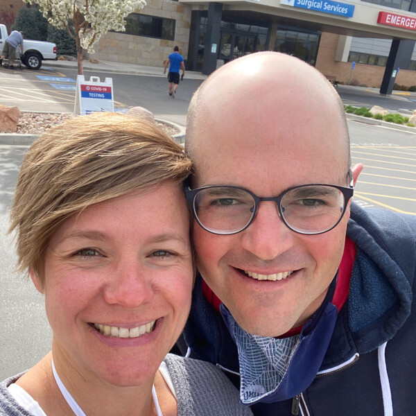 man and woman in front of a hospital