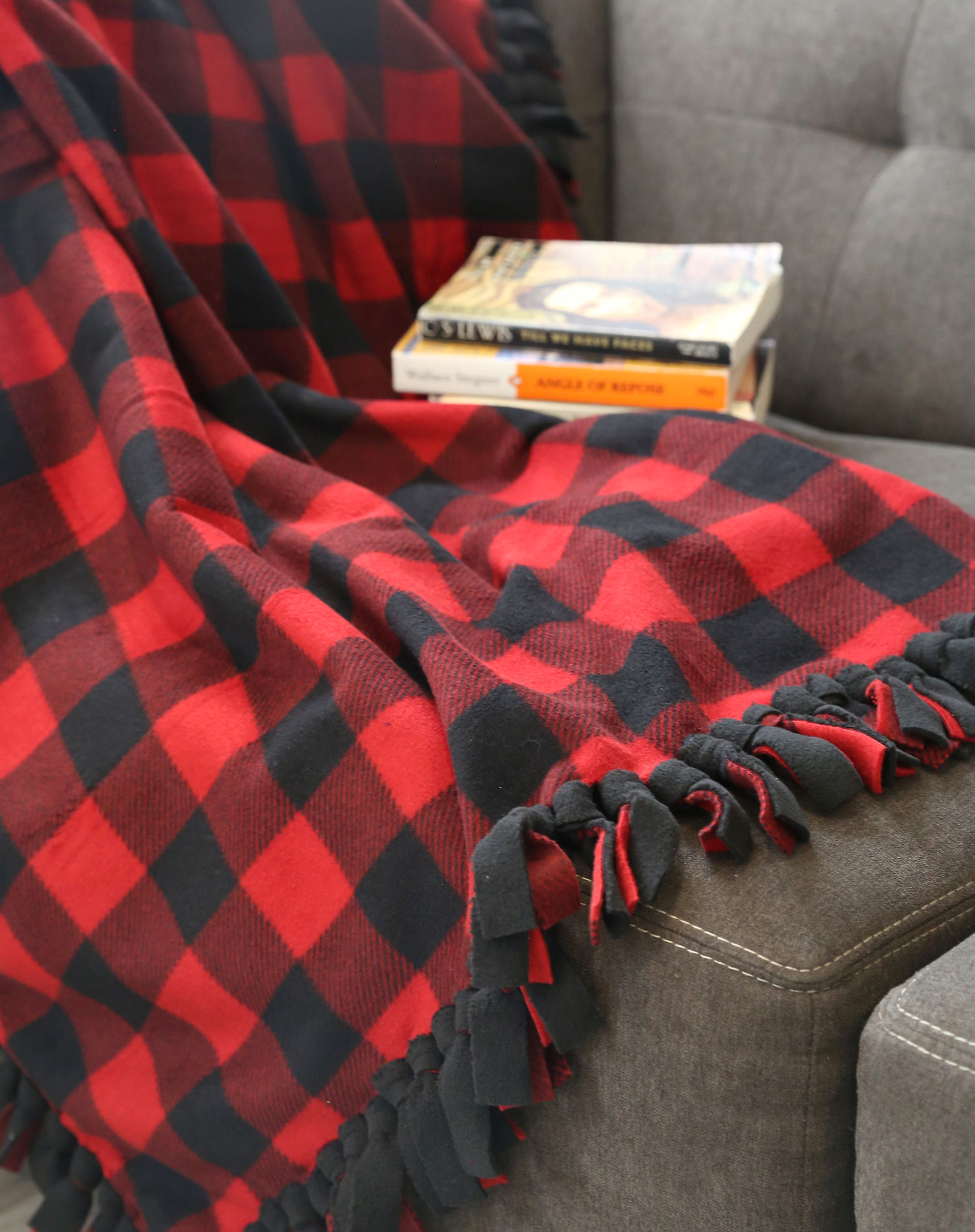 Fleece blanket on a couch with books