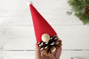 Hat glued onto gnome; wood bead glued on for nose