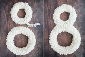 Two wreaths wrapped in white loop yarn, connected to form figure 8