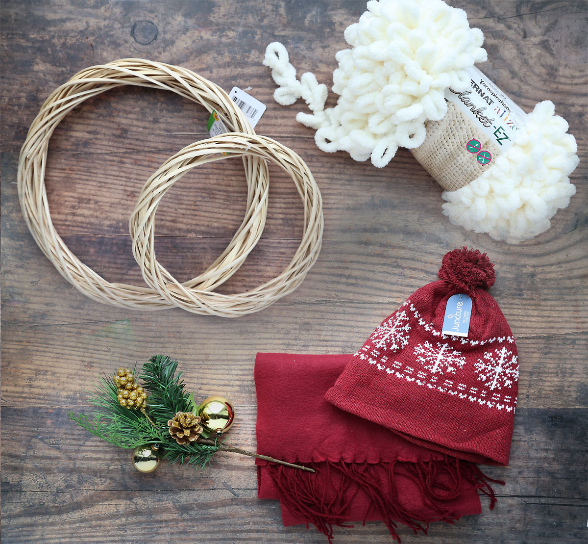 Supplies: two wreath forms, white loop yarn, hat and scarf, winter floral pick