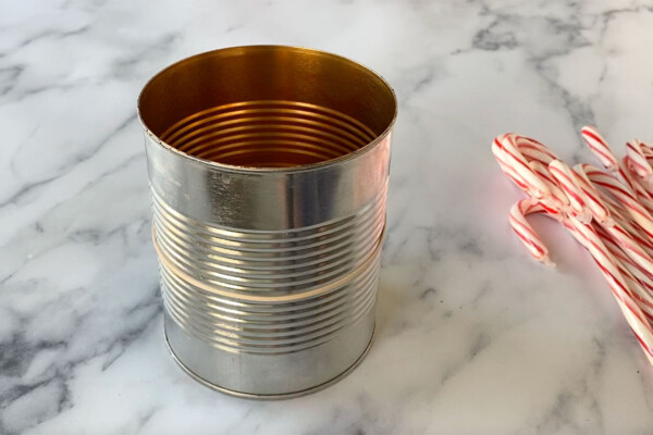 Empty food can with rubber band around it