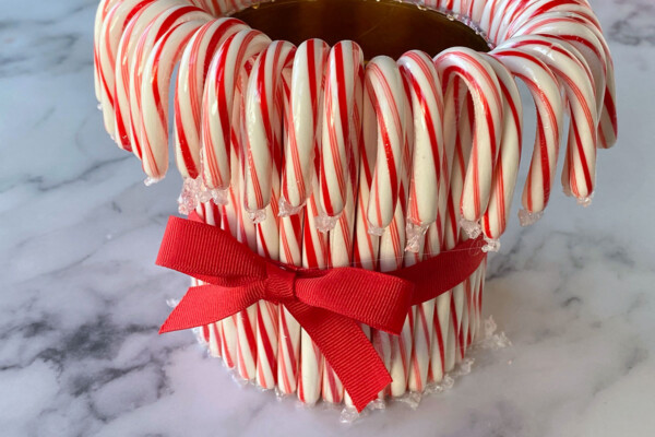 Tie a ribbon around the candy canes to cover the rubber band
