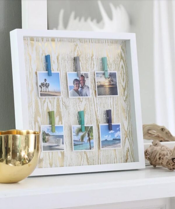 Shadowbox photo display using clothespins.