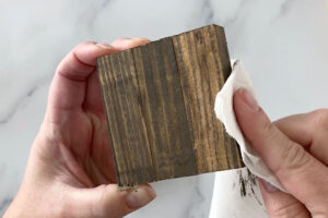 Wiping off paint from the base to give a stained look