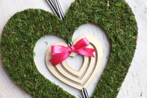 Pink bow added to the top of the small wood heart.