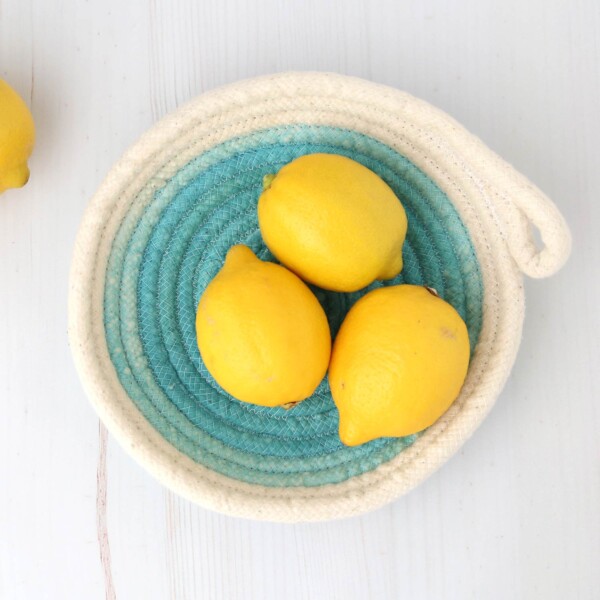 Bowl made from rope with lemons in it