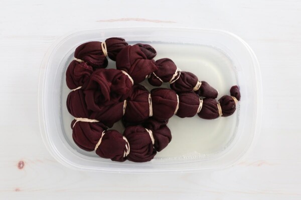 Sweatshirt in tub of bleach water.