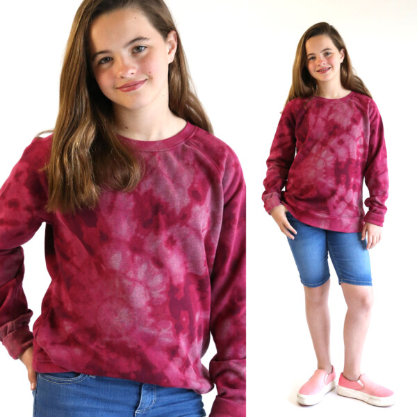 Girl wearing sweatshirt that's been reverse tie dyed with bleach