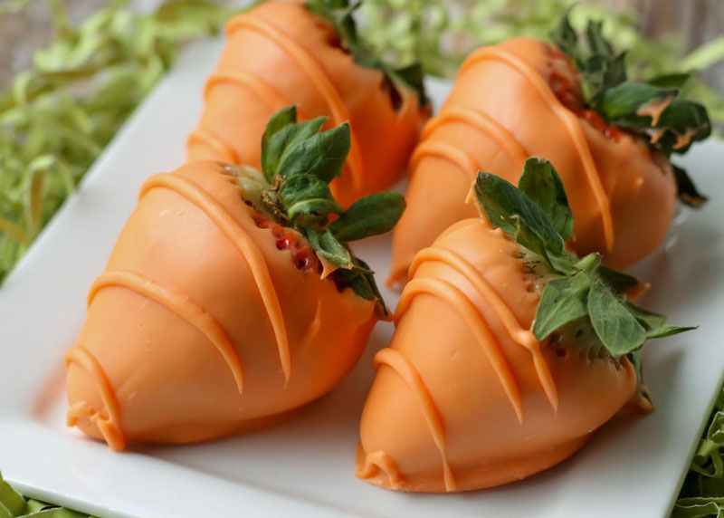 Chocolate covered strawberries that look like carrots.