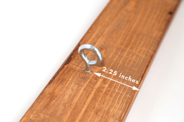 Hook screwed into underside of top piece, 2.25 inches from the front.