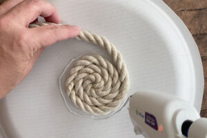 Gluing the rope to a paper plate
