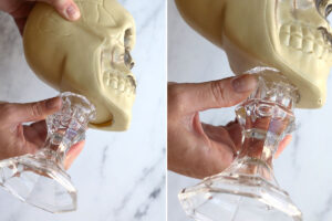 Sliding the candlestick into the opening on the bottom of the skull
