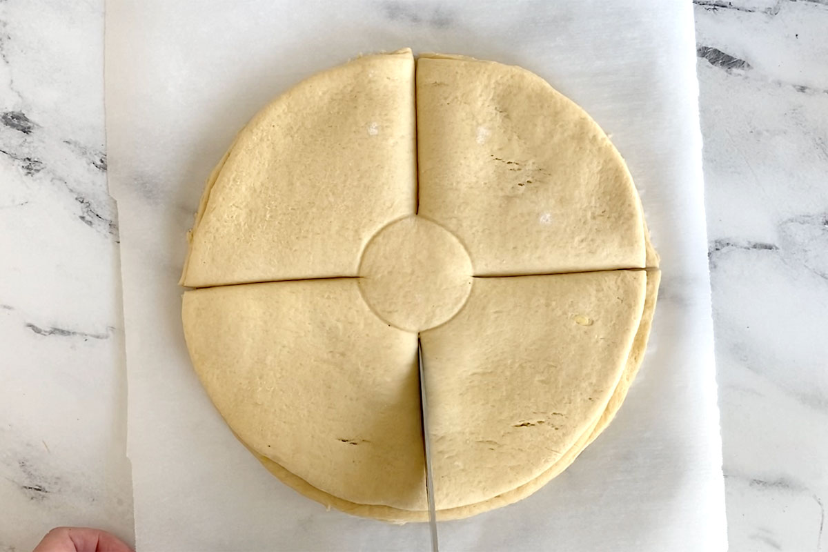 Layers of crescent dough and nutella cut into fourths.