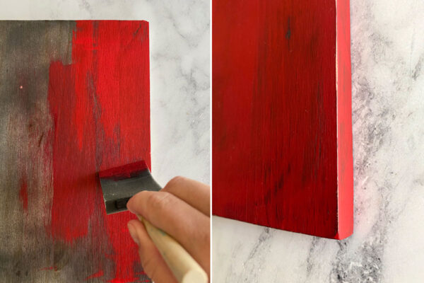 Dry brush painting red on the board.