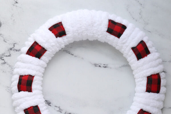 Woven ribbon and yarn wreath.