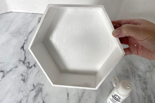 Hexagon shelf painted white.