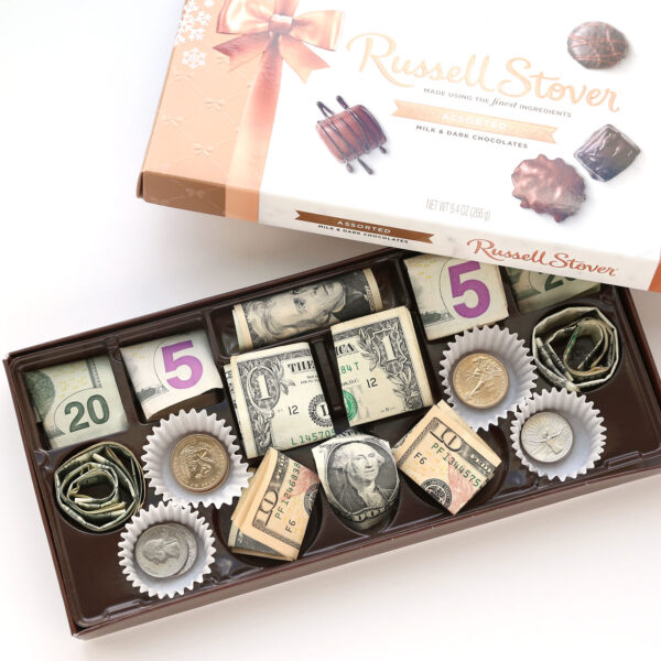 Box of chocolates with candy removed and money in their place.