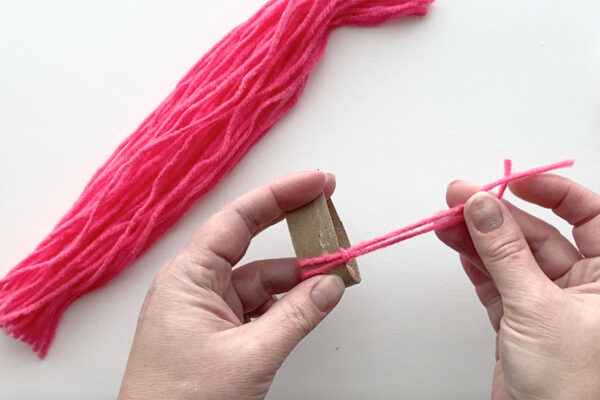 End of yarn pulled through the folded or looped end and pulled tight.