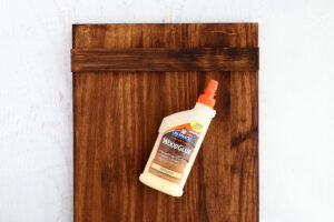 Slat glued across the board 1.5 inches from the top with wood glue.