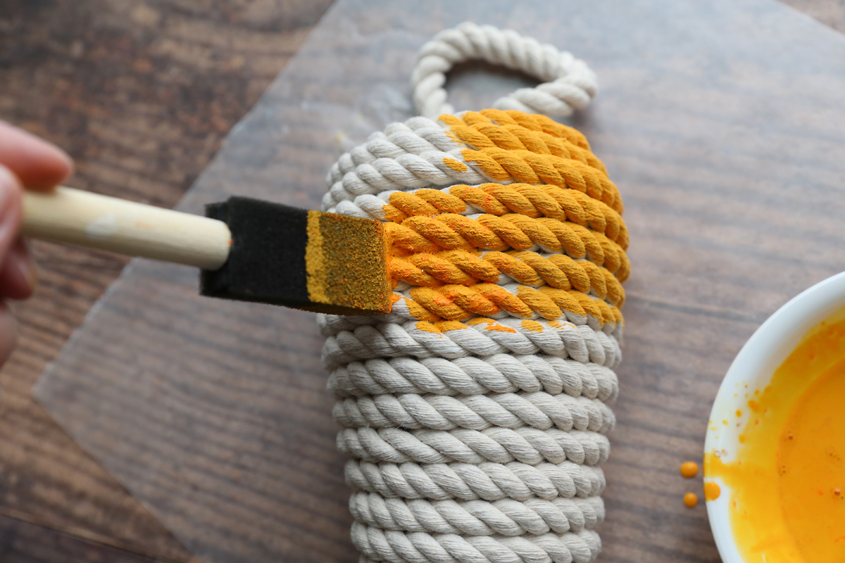Using foam paintbrush to paint the carrot.