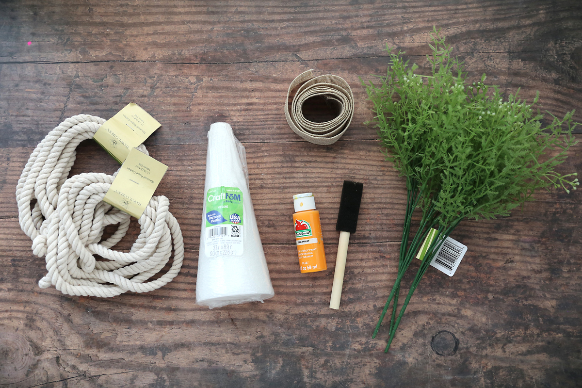 Cotton rope, foam cone, orange paint, paintbrush, burlap ribbon, faux greenery.