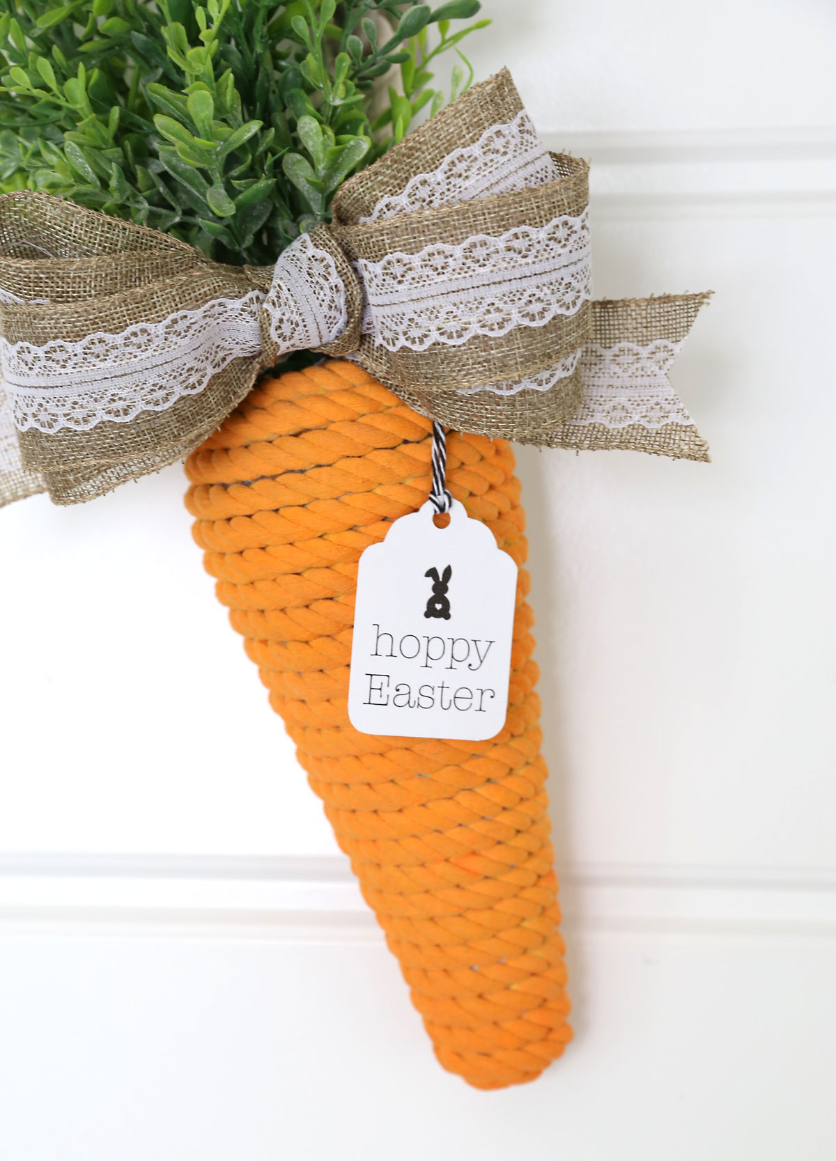 Carrot wreath with tag that says hoppy Easter.
