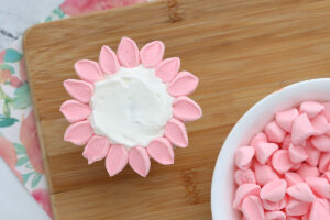 Marshmallow halves placed as petals around outside edge of cupcake.