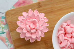 Two more circles of petals added to create a flower on the cupcake.