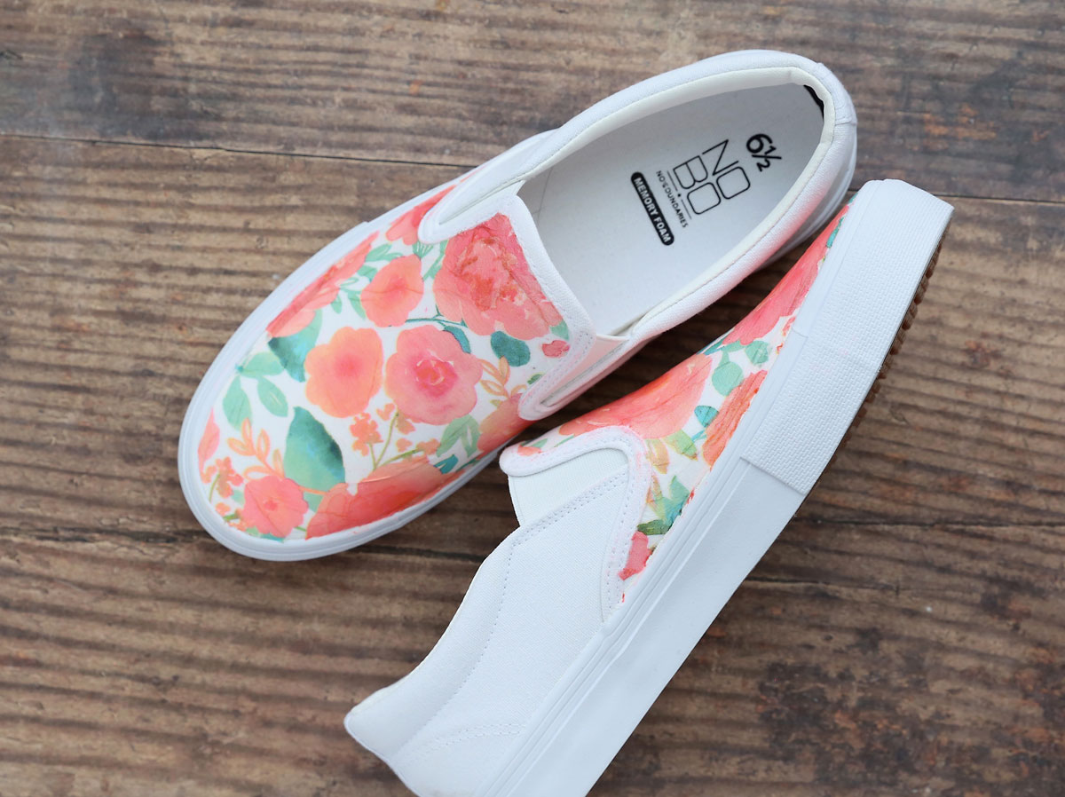 Floral canvas shoes that are white on the back.