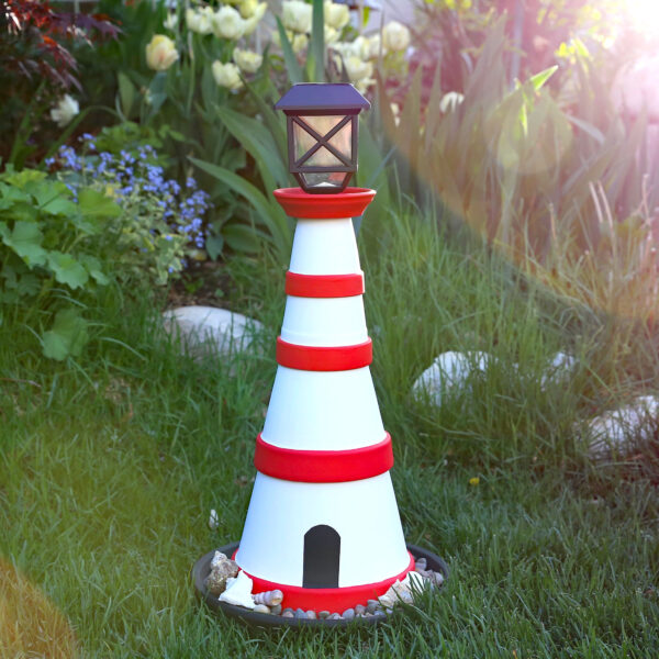 DIY lighthouse in a yard.
