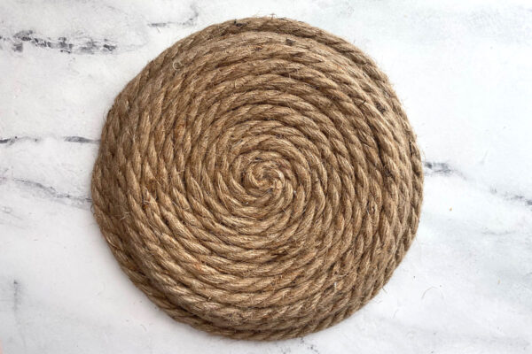 Paper plate entirely covered with rope.