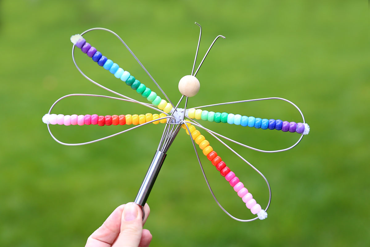 Whisk dragonfly decorated with colorful beads.