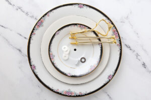 Three plates with holes drilled in the center; tiered tray hardware.