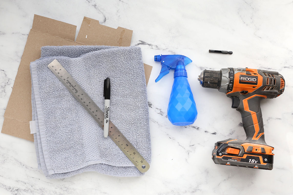 Cardboard, towel, Sharpie, ruler, spray bottle, drill, diamond tip drill bit.