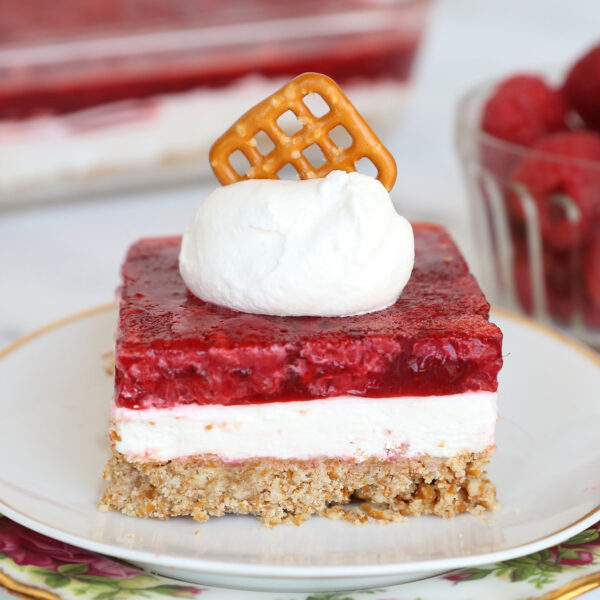 Slice of raspberry pretzel salad on a plate.