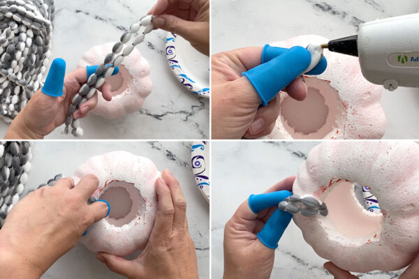 Gluing yarn inside the circle cut out of the pumpkin.