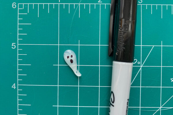 Sharpie used to draw eyes and mouth on the ghost.