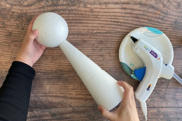 Gluing the styrofoam ball on top of the styrofoam cone.