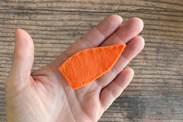 Nose shape cut from orange felt.