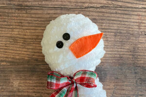 Small buttons glued on as eyes; nose glued on.